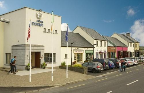 a building on the side of a street with cars at Hotel Doolin in Doolin