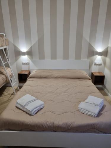 a bedroom with a bed with two towels on it at Cala Di Luna House in Vietri sul Mare