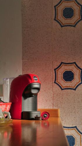 a red appliance sitting on top of a table at Villa La Caletta in Carloforte