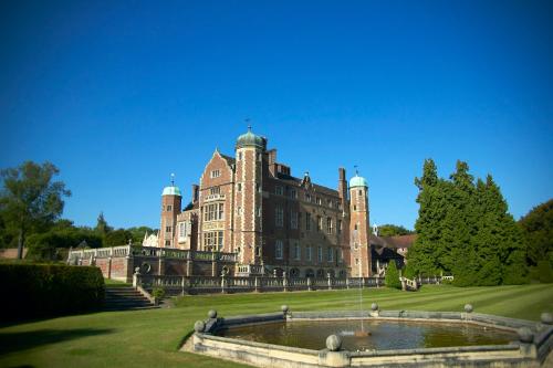a large building with a fountain in front of it at Madingley Hall in Cambridge