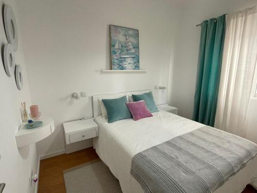 a small bedroom with a bed and a sink at Blue Home Monte Gordo in Monte Gordo
