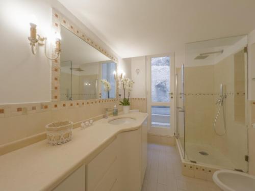 a bathroom with a sink and a shower and a mirror at Capri center holidays in Capri