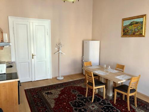 a dining room with a table and a refrigerator at Salve Teplice in Teplice