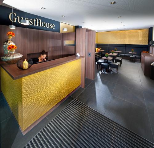a man sitting at a counter in a restaurant at GuestHouse Mannheim in Mannheim