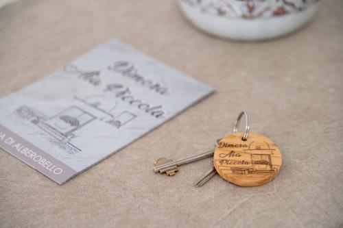 a pair of keychains sitting next to a book at Dimora Aia Piccola in Alberobello