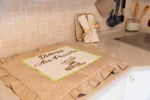 a kitchen counter with a cake on a towel at Dimora Aia Piccola in Alberobello