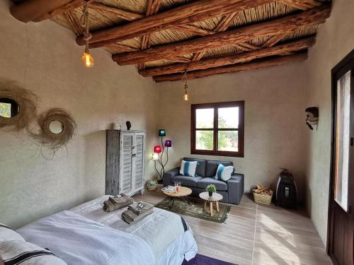 a bedroom with a large bed and a couch at Soo Bin in Bine el Ouidane