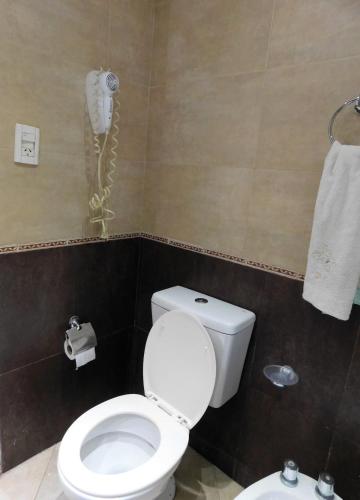 a bathroom with a toilet and a phone on the wall at No me Olvides -Salta-somos mascoteros in Salta