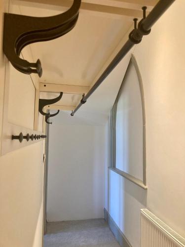 a hallway in a house with a window at Trawscoed Mansion,Central Wing in Aberystwyth