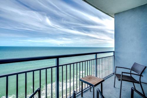 a balcony with two chairs and a table and the ocean at Fabulous Ocean Front Penthouse Condo, OO Resort, 21st Fl in Myrtle Beach