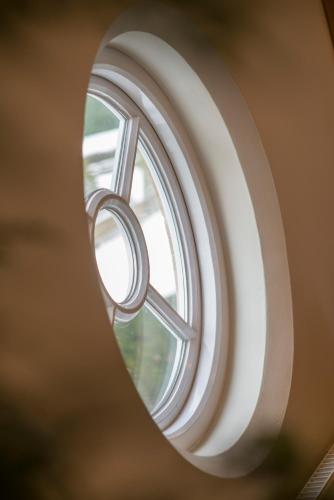 a window with a ring in a mirror at Madingley Hall in Cambridge