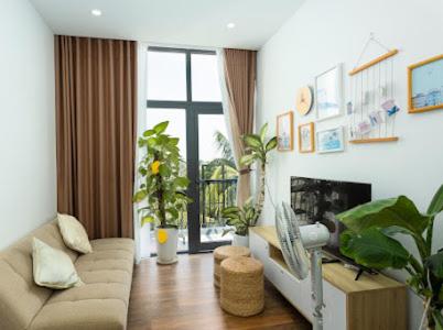 a living room with a couch and a fireplace at Alina Retreat in Hiếu Nhơn
