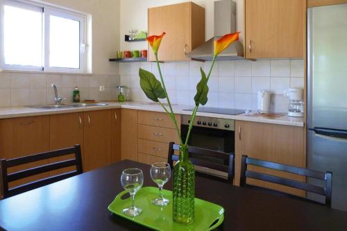 a kitchen with a table with a vase with flowers in it at Villa in Nopigia with shared pool in Nopíyia