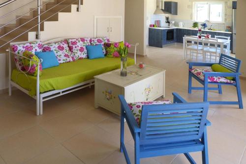 a living room with a couch and two chairs at Villa in Nopigia with shared pool in Nopíyia