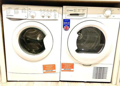 two washing machines are sitting next to each other at Dunamis Staycation 2 in Croydon