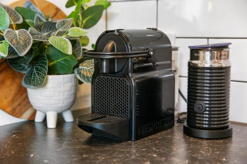 a coffee maker sitting on a counter next to a camera at Getaway On Little in Daylesford