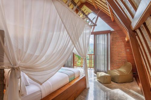 a bedroom with a canopy bed and a window at Like living in a romantic Balinese painting in Sidemen