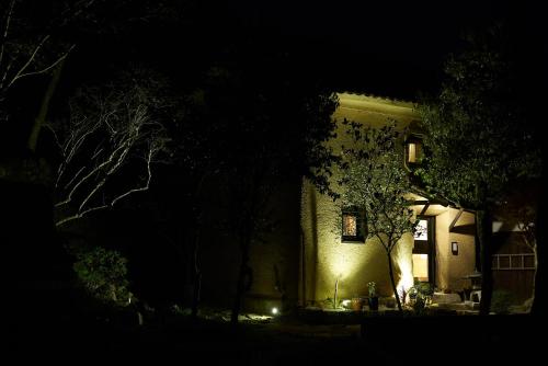 a house at night with lights on the front of it at OldbutNew 蔵 in Hara