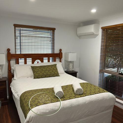 a bedroom with a bed with two towels on it at Seashells Holiday House - Kalbarri in Kalbarri