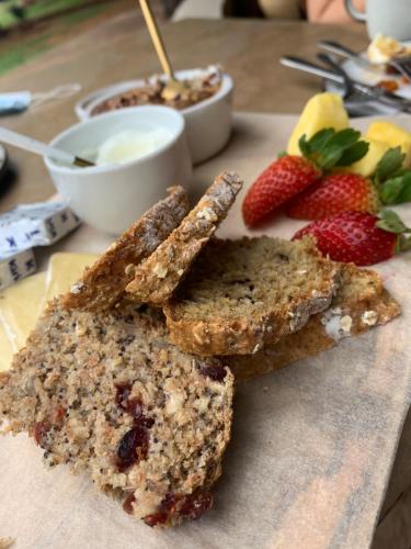a piece of bread on a cutting board with strawberries at Itaga Luxury Private Game Lodge in Bela-Bela