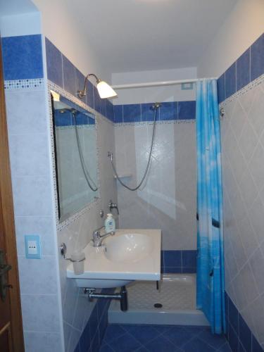 a bathroom with a sink and a shower at Chiaia Apartments by Caseaponza it in Ponza