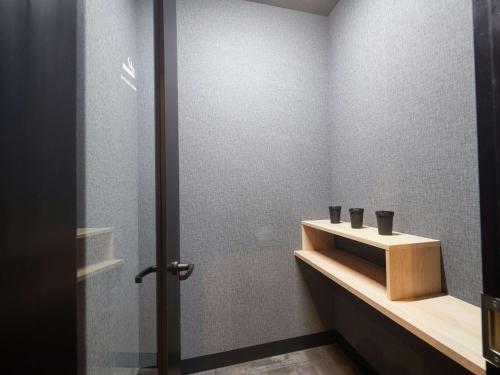 a bathroom with a sink and a shower at CABIN&HOTEL CONSTANT NAHA in Naha