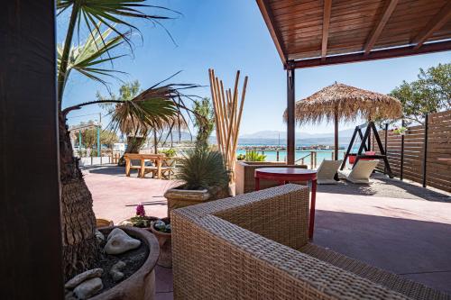 a patio with a view of the ocean and a swing at Villa Marathoula in Marathi