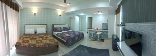 a bedroom with two beds and a fireplace at Homestay Apartment KB @ D'perdana Condo in Kota Bharu
