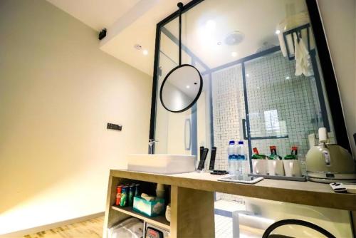 a bathroom with a sink and a mirror at Rest Chinatown Hotel in Singapore