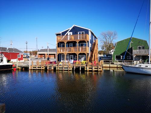 a house on a dock with boats in the water at The Inn at Fisherman's cove in Halifax