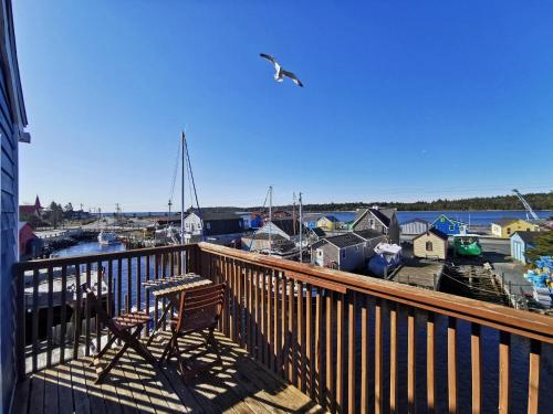a balcony with a bird flying over a marina at The Inn at Fisherman's cove in Halifax