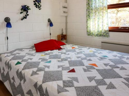 a bedroom with a bed with a quilt on it at 6 person holiday home in Hadsund-By Traum in Hadsund