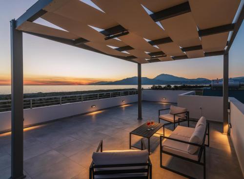 a roof deck with a view of the ocean at Grand Sea View Luxury Villa in Kalamaki Heraklion