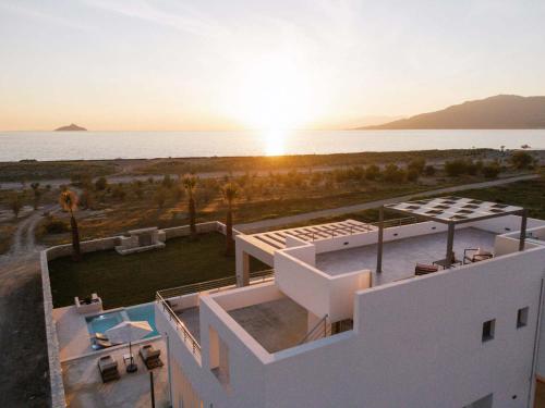 a white house with a view of the ocean at Grand Sea View Luxury Villa in Kalamaki Heraklion