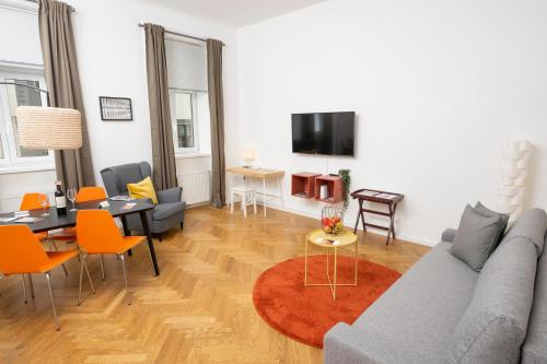 a living room with a couch and a dining room at Luxury Suites Liechtenstein in Vienna