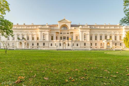 a large building with a lawn in front of it at Luxury Suites Liechtenstein in Vienna