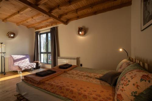 a bedroom with a bed and a chair and a window at Adventure Camp Emen in Emen