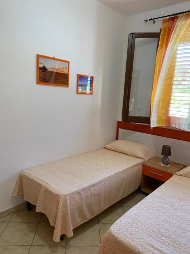 Giường trong phòng chung tại Appartamento vicino la spiaggia