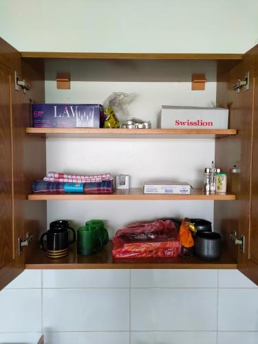 a pantry with wooden shelves filled with food at Apartman Zelenika in Banja Koviljača