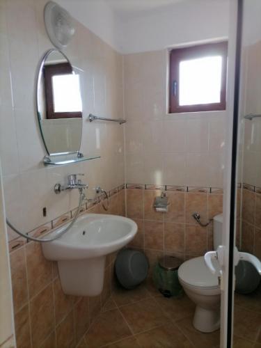 a bathroom with a sink and a toilet at Ivet Guest Rooms - Obzor in Obzor