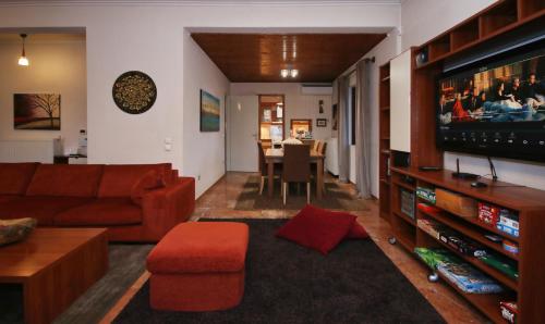 a living room with a couch and a television at Villa Arcadia in Vlakhérna