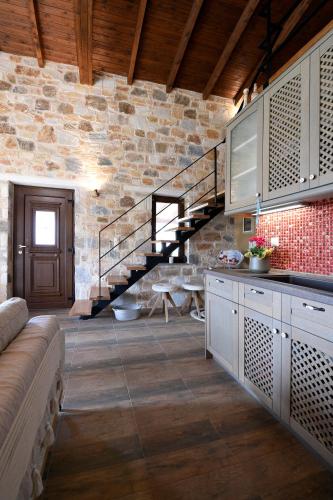 a kitchen with a staircase in a stone building at Pinelia Home in Mirtófiton
