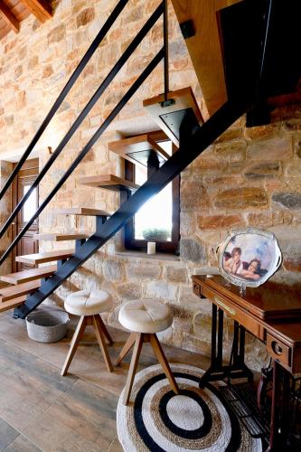 a staircase with two stools and a mirror on a table at Pinelia Home in Mirtófiton