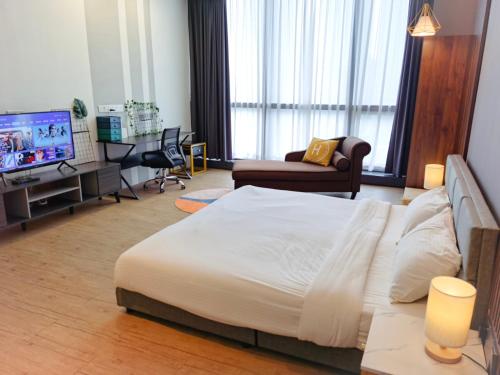 a bedroom with a large bed and a living room at The Parkville - Bangsar Trade Centre in Kuala Lumpur