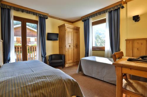 Postel nebo postele na pokoji v ubytování Hotel Crampon