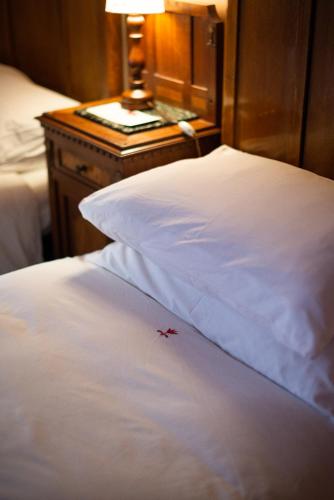 a close up of a white bed with a star on it at Palazzo Romani Adami in Fermo