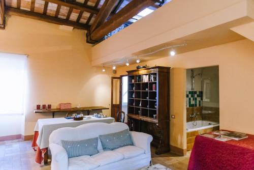 a living room with a white couch and a table at Palazzo Romani Adami in Fermo