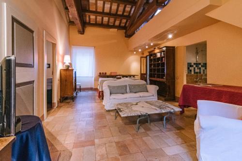 a living room with two couches and a table at Palazzo Romani Adami in Fermo