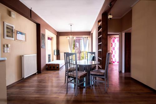 a dining room with a table and chairs at Southgate Apartments in Agios Georgios