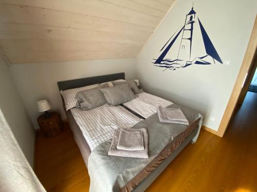 a bedroom with a bed with a sail on the wall at Marina Lubkowo Dom Czarna Perła in Lubkowo